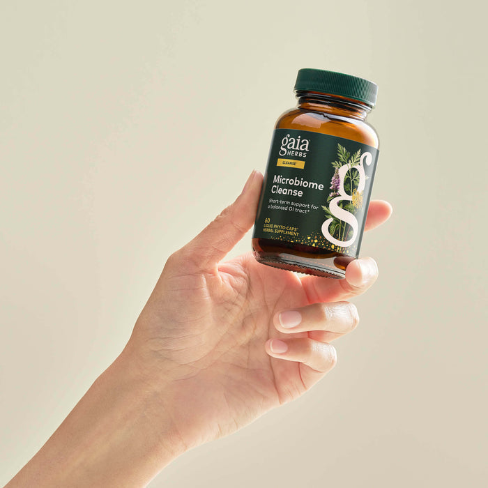 Microbiome Cleanse 60 Count Bottle Held In A Person's Hand