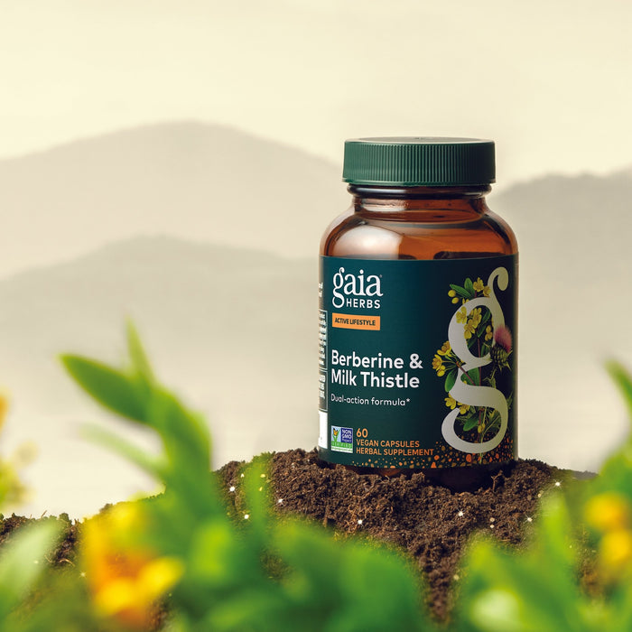 Berberine & Milk Thistle 60 count Bottle on soil in front of a Blue Ridge Mountain Background