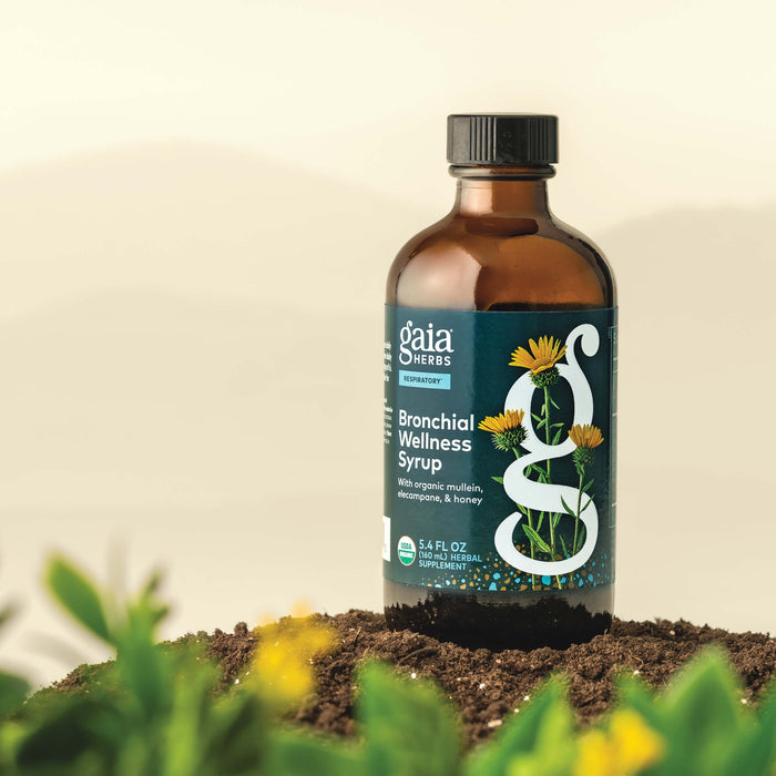 Gaia Herbs Bronchial Wellness Syrup 5.4 ounce bottle on a natural background with plants.