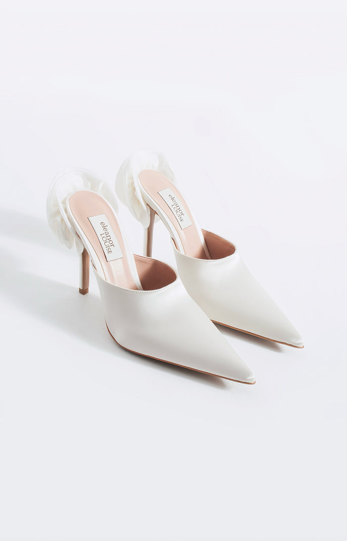 White pointed-toe high-heeled shoes on a white background