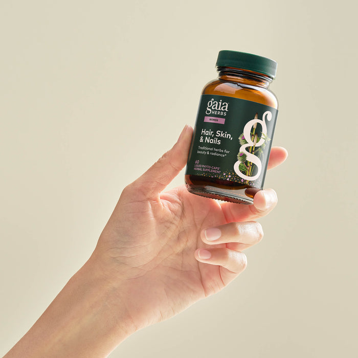 Hair, Skin, and Nails Support 60 count Bottle Held In A Person's Hand