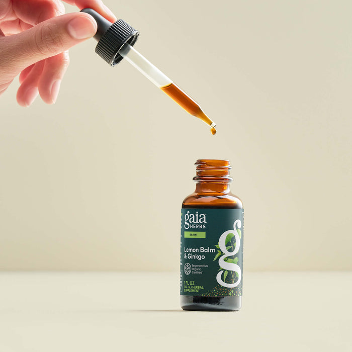 Gaia Herbs Lemon Balm & Ginkgo bottle with dropper on a beige background