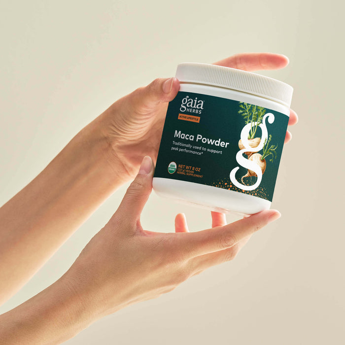Maca Powder 8 ounce Bottle Held In A Person's Hand