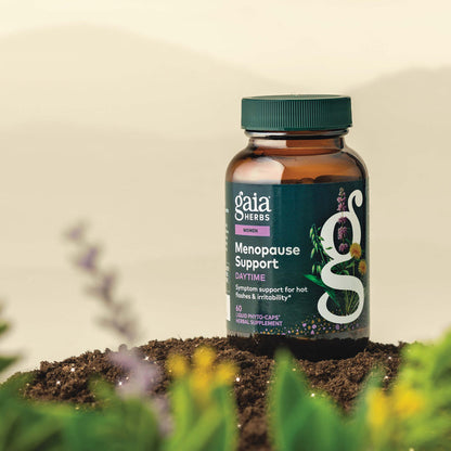 Gaia Herbs Menopause Support Daytime 60 count bottle on a natural background with plants.