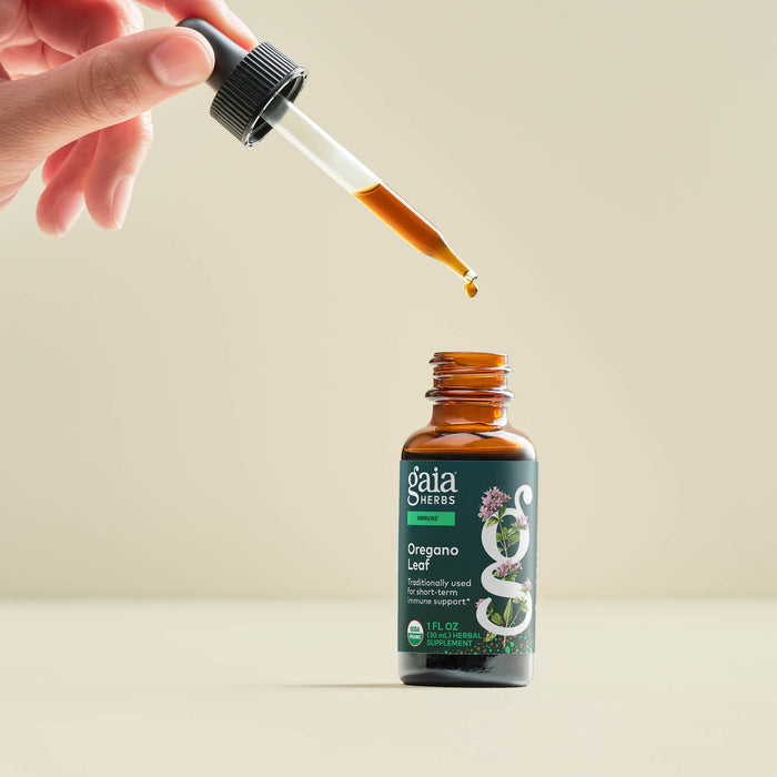 Oregano Leaf 1 ounce Bottle Held In A Person's Hand