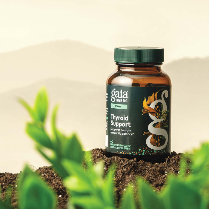 Gaia Herbs Thyroid Support 60 count supplement bottle with plants in the foreground