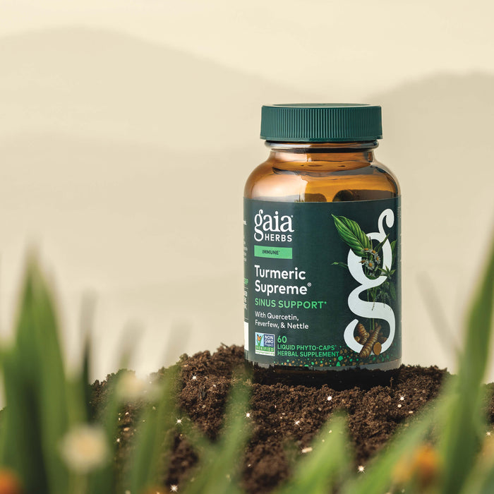 Gaia Herbs Turmeric Supreme 60 count supplement bottle on a natural background with plants.