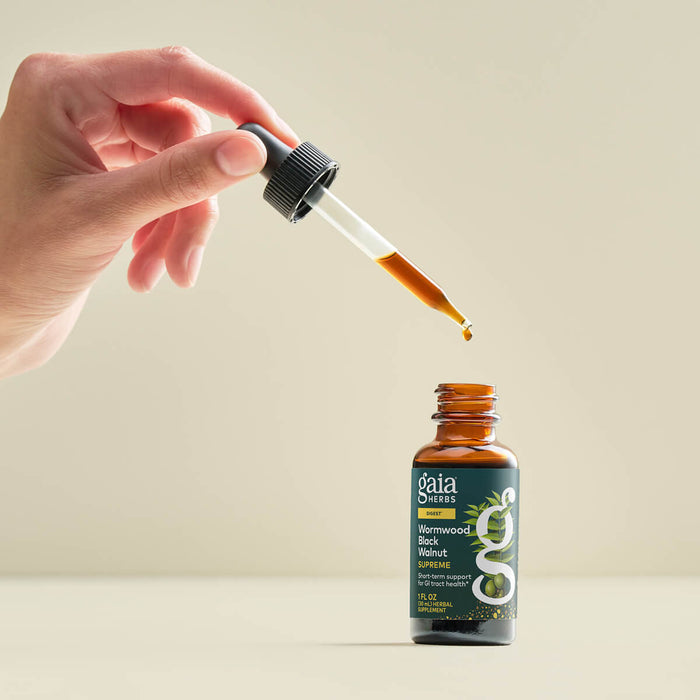 Wormwood Black Walnut Supreme 1 Ounce Bottle Held In A Person's Hand